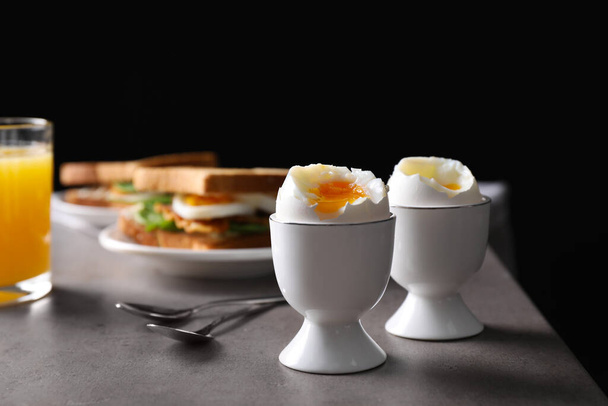 Soft boiled eggs served on grey table. Space for text - Φωτογραφία, εικόνα