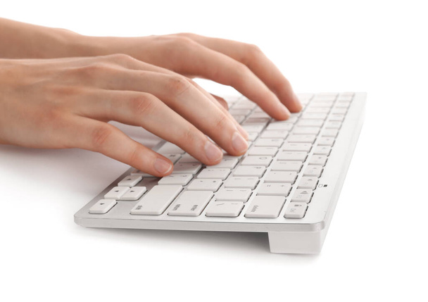 Hands with modern computer keyboard on light background - Photo, Image