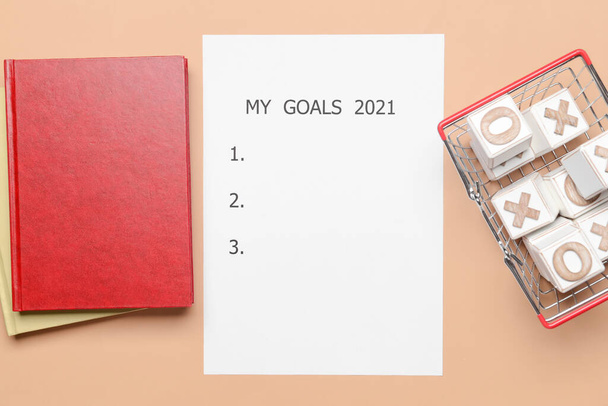 Empty to do list on 2021 year, notebooks and tick-tack-toe game on color background - Foto, imagen