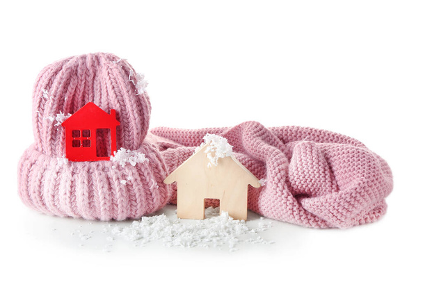 Figures of house, snow and warm clothes on white background. Concept of heating season - Photo, Image