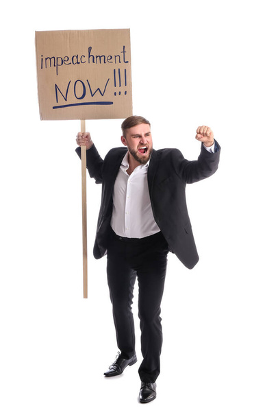Protesting young man on white background. Impeachment concept - Photo, Image