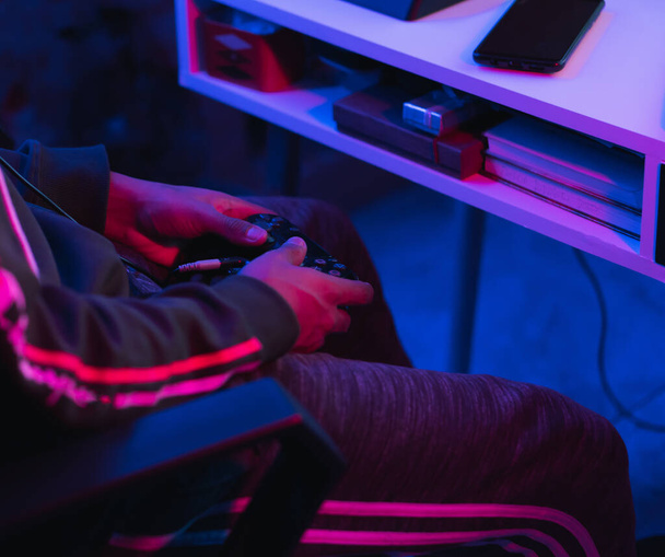 A closeup of a male gamer playing with a controller and streaming a video game online - Φωτογραφία, εικόνα