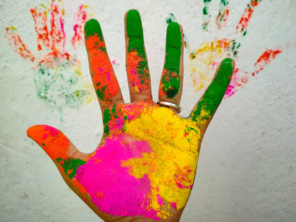 A closeup shot of a human's palm covered in colorful paint - Φωτογραφία, εικόνα