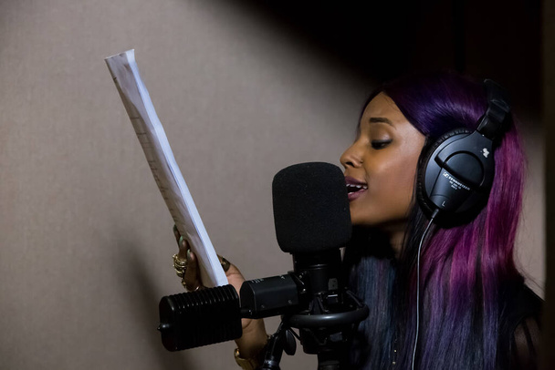 Johannesburg, South Africa - April 28, 2015: Vanessa Mdee, Tanzania singer recording vocal part on Afro-pop song in studio - Photo, image