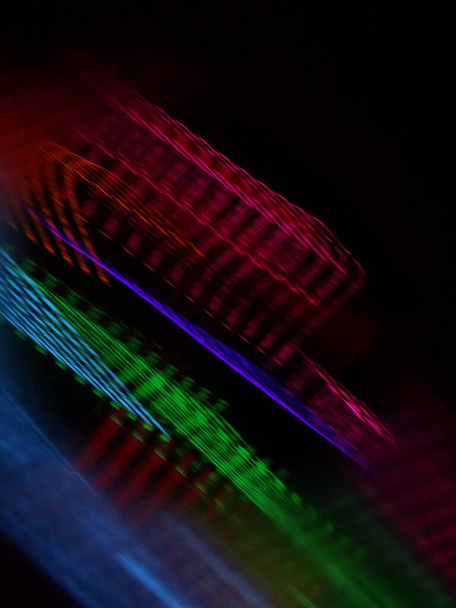 A vertical shot of the rhythm of colorful lights on a black background - Photo, image