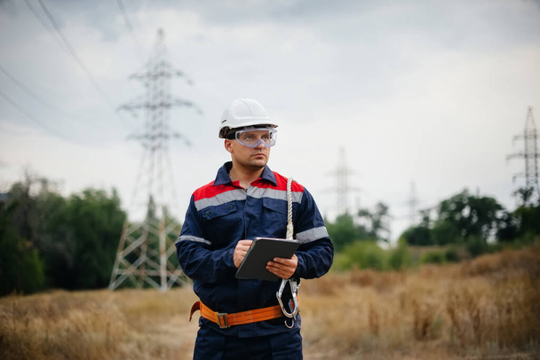 An energy worker inspects power lines. Energy - Photo, image