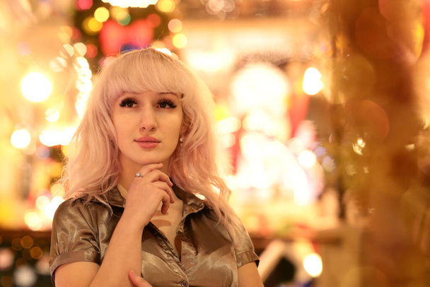 blond woman close up portrait with Christmas illuminated decorations - Photo, Image
