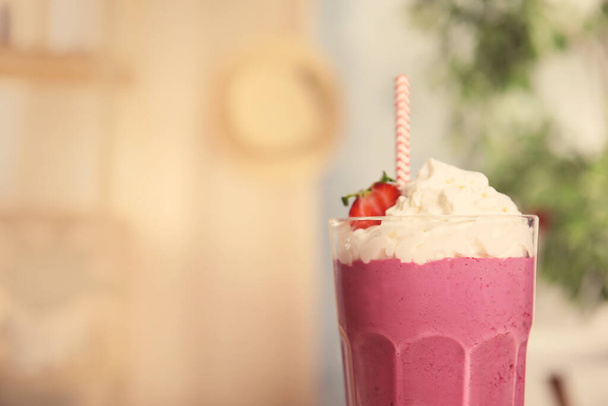 Tasty fresh milk shake with strawberry in glass indoors, closeup. Space for text - Zdjęcie, obraz