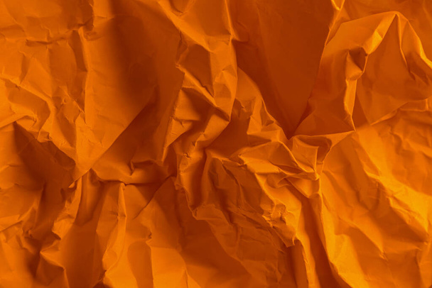 Texture of orange crumpled paper as background, top view - Photo, Image