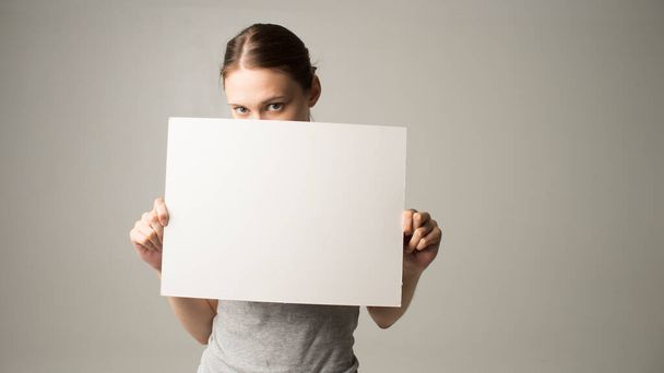 woman holding a sheet of paper in her hand - Photo, Image