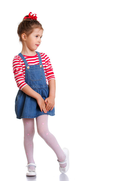 beautiful little girl in short denim dress - Фото, изображение