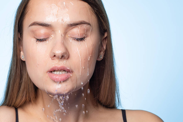 Clean skin, drops and trickles of water on the face. Young beautiful woman, - Фото, зображення