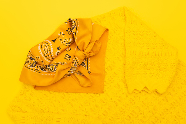 top view of scarf with ornate on clothing isolated on yellow  - Fotografie, Obrázek