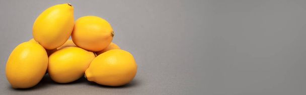 ripe and yellow lemons on grey background, banner - Photo, Image