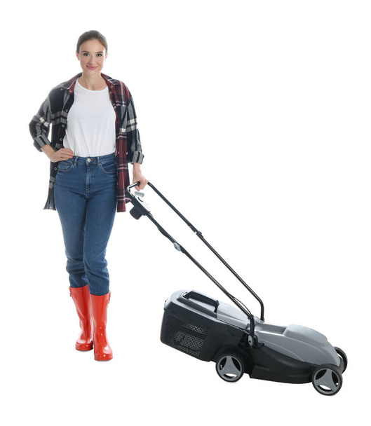 Young woman with modern lawn mower on white background - Fotoğraf, Görsel