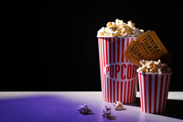 Delicious popcorn and tickets on table. Space for text - Photo, image