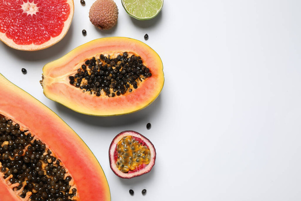 Fresh ripe papaya and other fruits on white background, top view - Photo, image