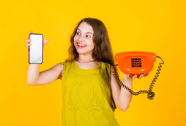 child with vintage and modern telephone. childhood development. pretty teenage girl in dress talk on phone. kid speak on retro phone. fashion and beauty. pleasant conversation. business communication - Foto, Imagem