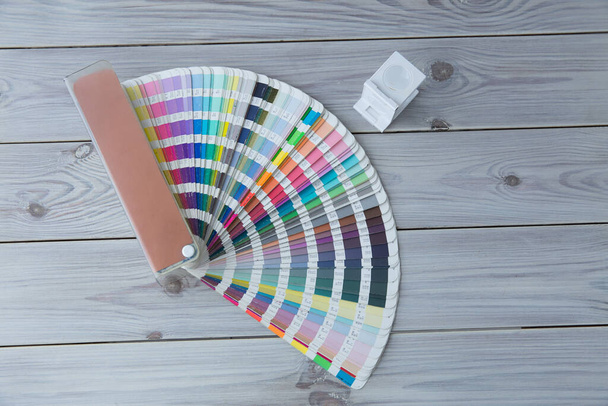 Press color management. Cmyk stripe loupe and color palette on the wooden background. - Photo, Image