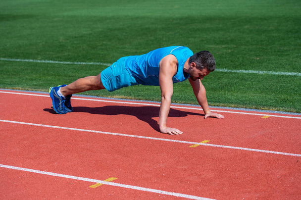 muscular guy stand in plank making push up on sport training, workout - Φωτογραφία, εικόνα