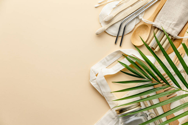 Cotton bag, bamboo cutlery, glass jar, bamboo toothbrushes, hairbrush and straws on color background, flat lay. - Fotoğraf, Görsel