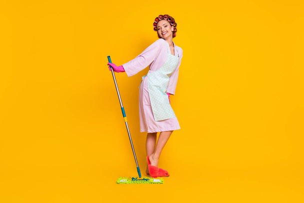 Full length body size view of attractive cheery glamorous maid cleansing floor posing isolated bright yellow color background - Foto, Bild