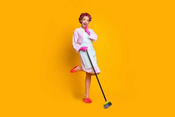 Full length body size view of attractive cheerful glad maid jumping sweeping cleanup neat isolated bright yellow color background - Φωτογραφία, εικόνα