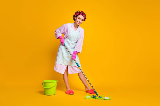 Full body photo of positive maid girl wash floor mop wear bath robe gloves isolated shine color background - Foto, afbeelding