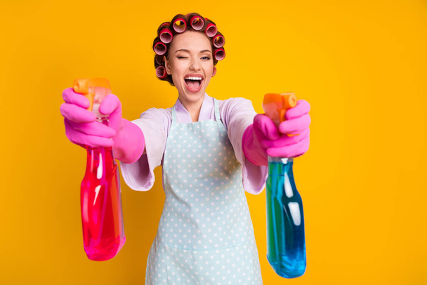 Photo of excited girl wink shoot spray bottle chemical wear latex gloves bath robe isolated shine color background - Фото, изображение