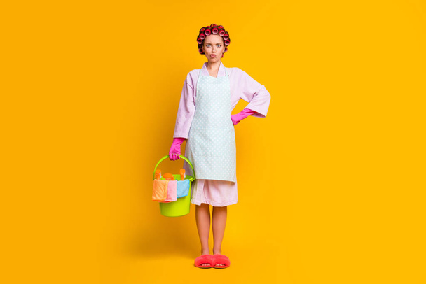 Full length photo disappointed girl hold bucket spray bottle wear gloves bath robe isolated shine color background - Φωτογραφία, εικόνα