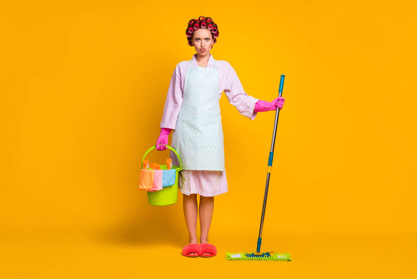 Full size photo of sad girl hold bucket bottle spray mop wear gloves bath robe isolated shine color background - Foto, afbeelding