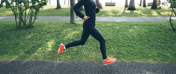 Fitness woman running training for marathon on sunny tropical park trail - Zdjęcie, obraz