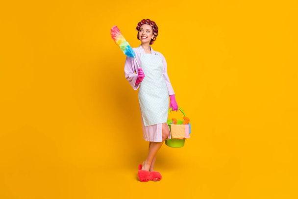 Full length photo of positive girl hold bucket duster wear bath robe gloves isolated shine color background - Photo, image