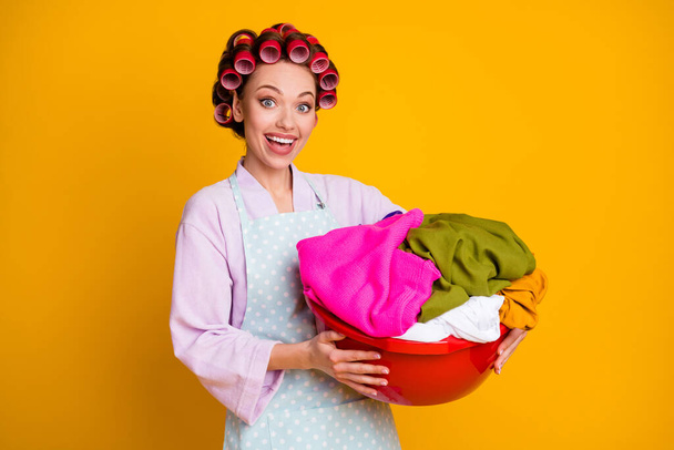 Photo of excited girl heap dirty clothes hold wear bath robe isolated bright shine color background - Foto, Imagen