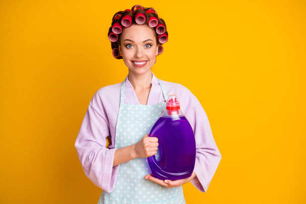 Photo of positive girl hold big bottle laundry liquid wear outfit isolated over bright shine color background - Foto, immagini