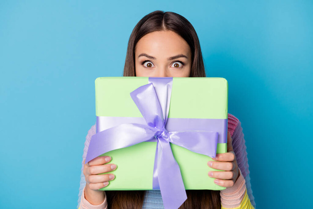 Photo of astonished girl close face gift box receive 14-february 8-march wear pullover isolated blue color background - Foto, Imagem