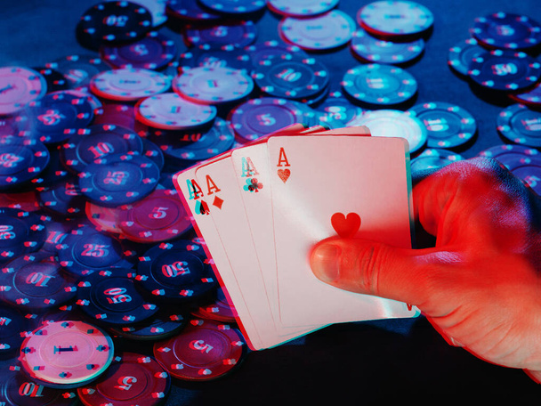 mens hands hold aces cards against the background of playing chips. the photo shows smoke. 3D glitch virtual reality effect - Foto, Imagen