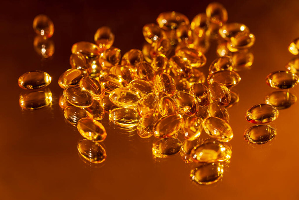 Many capsules Vitamins Omega 3 on gold background.  Macro, high resolution product. - Foto, Imagem