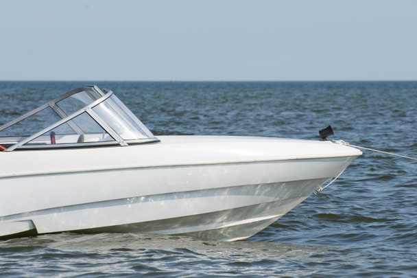Uma lancha branca ou barco a motor flutua no mar azul. - Foto, Imagem