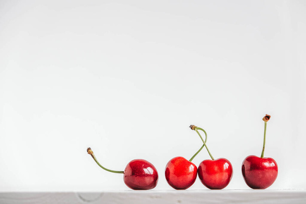 Fresh ripe cherries on the white wooden background. Copy, empty space for text. - Photo, Image