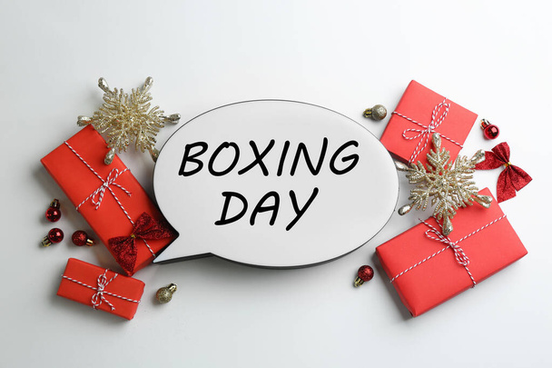 Speech bubble with phrase BOXING DAY and Christmas decorations on white background, flat lay - Foto, afbeelding