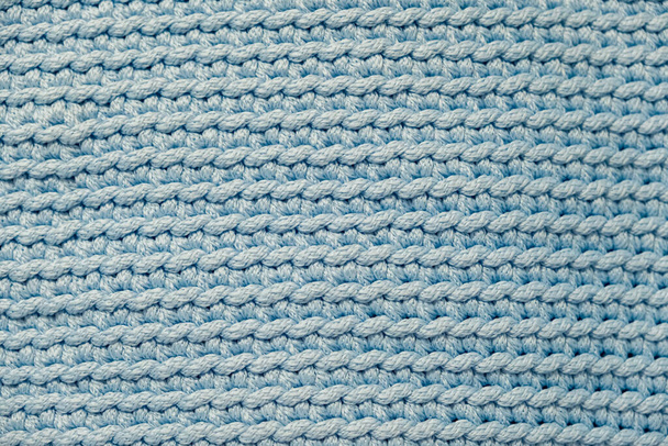 Light soft blue knitted fabric texture background. Top view. Copy, empty space for text. - Photo, Image