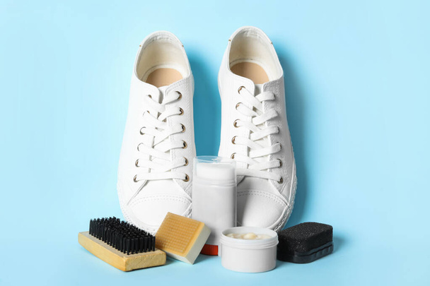 Composition with stylish footwear and shoe care accessories on light blue background - Photo, image