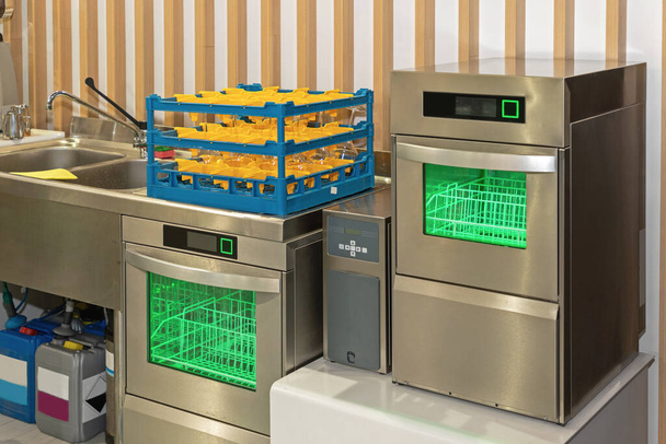 Two Dishwasher Machines With Glass Rack in Restaurant Kitchen - 写真・画像