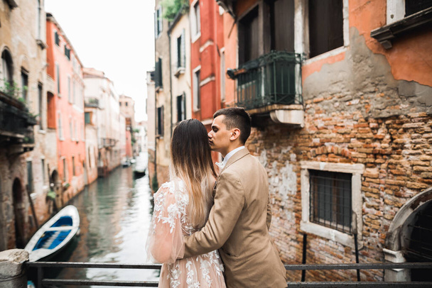 Wedding couple on the nature is hugging each other. Beautiful model girl in white dress. Man in suit.Venice, Italy - Fotoğraf, Görsel