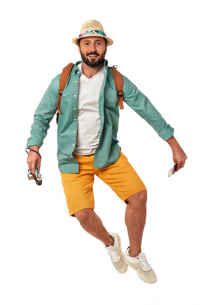 Cheerful man with backpack and photo camera on white background - Fotó, kép