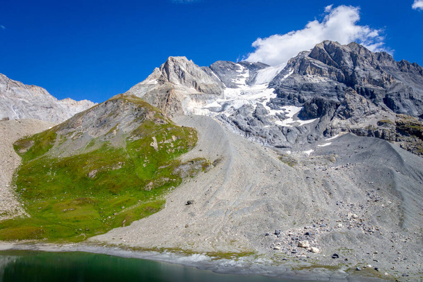 Long lake and Grande Casse Alpine glacier landscape in French alps - Fotó, kép