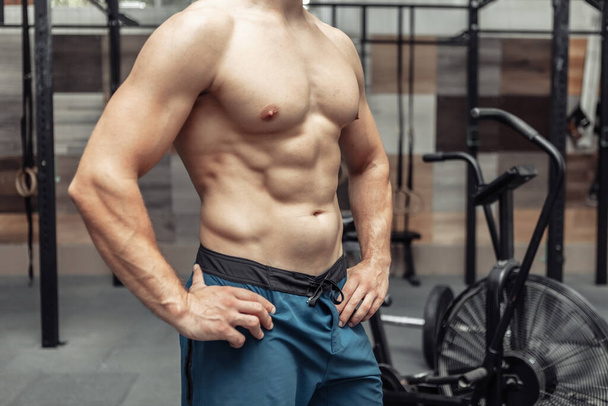 Muscular man naked torso in a modern health club - Foto, immagini