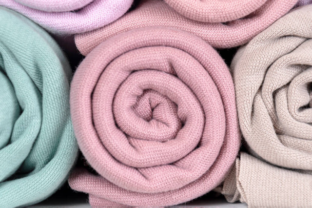 Rolls of knitted fabric in different shades, lilac, purple, gray, close-up - Fotoğraf, Görsel