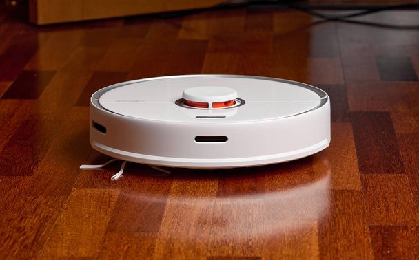 Smart Robot Vacuum Cleaner Xiaomi roborock s5 max on wood floor. Robot vacuum cleaner performs automatic cleaning of the apartment. 04.12.2020, Rostov region, Russia - Foto, afbeelding